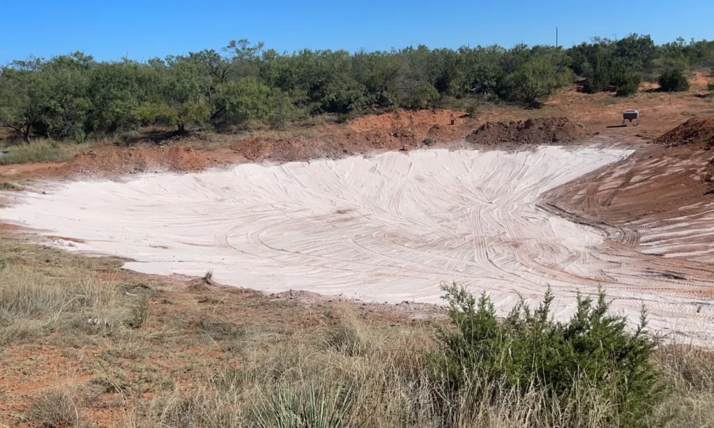 A pond under construction using Bentonite as its sealing agent.