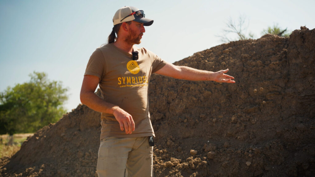 Examining soil types before the construction of a pond in central Texas.