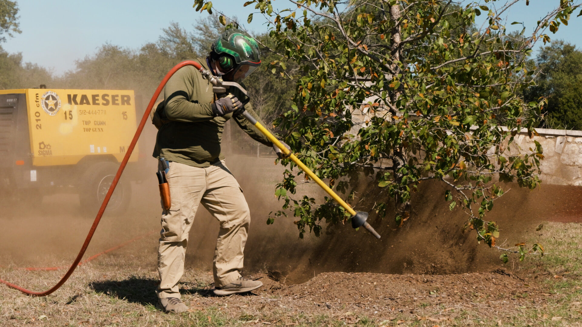 Air spade exposing buried root flare of landscape tree