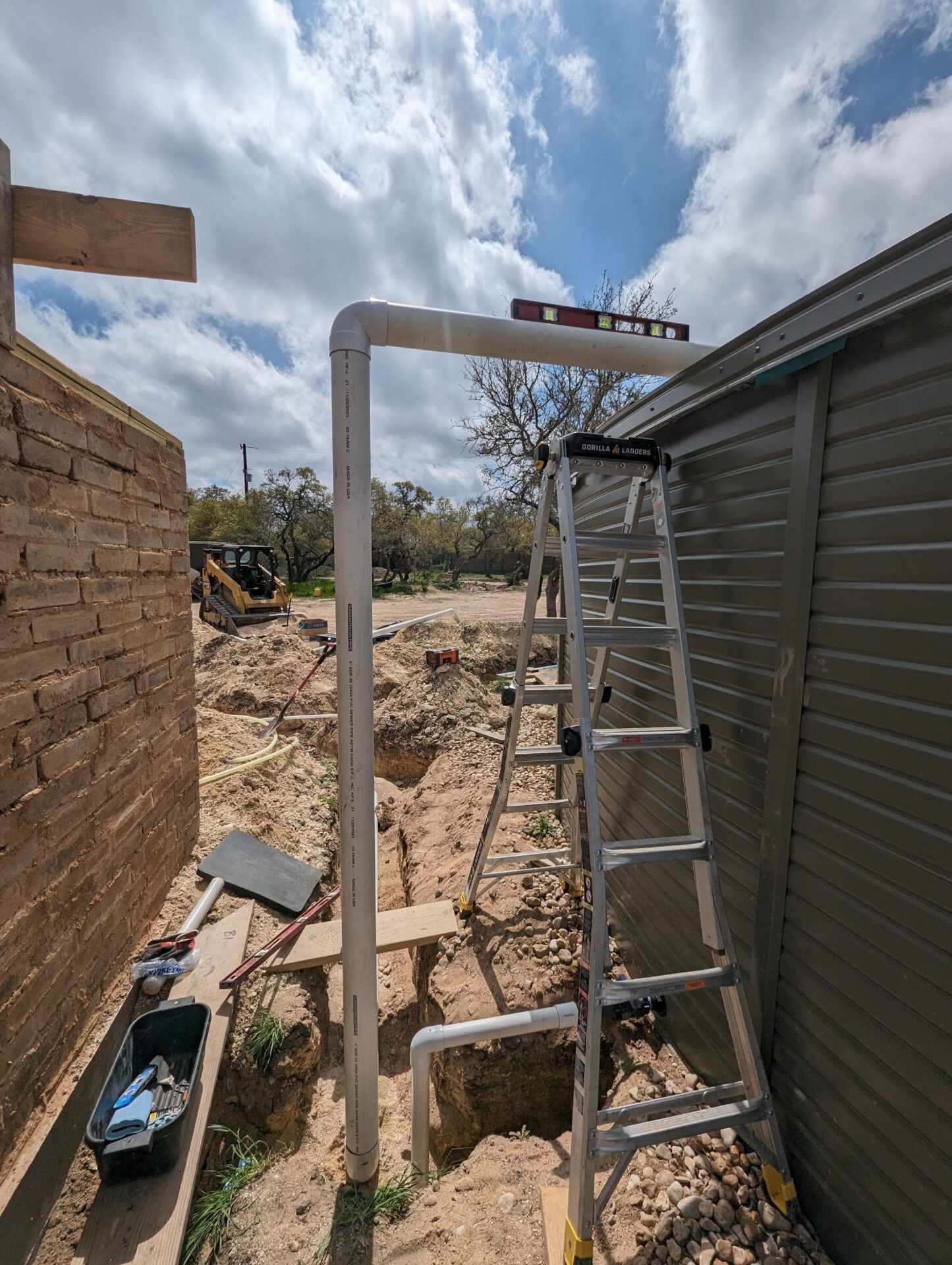 Rainwater tank plumbed to collect roof runoff from both homes on a Central Texas ecological build.